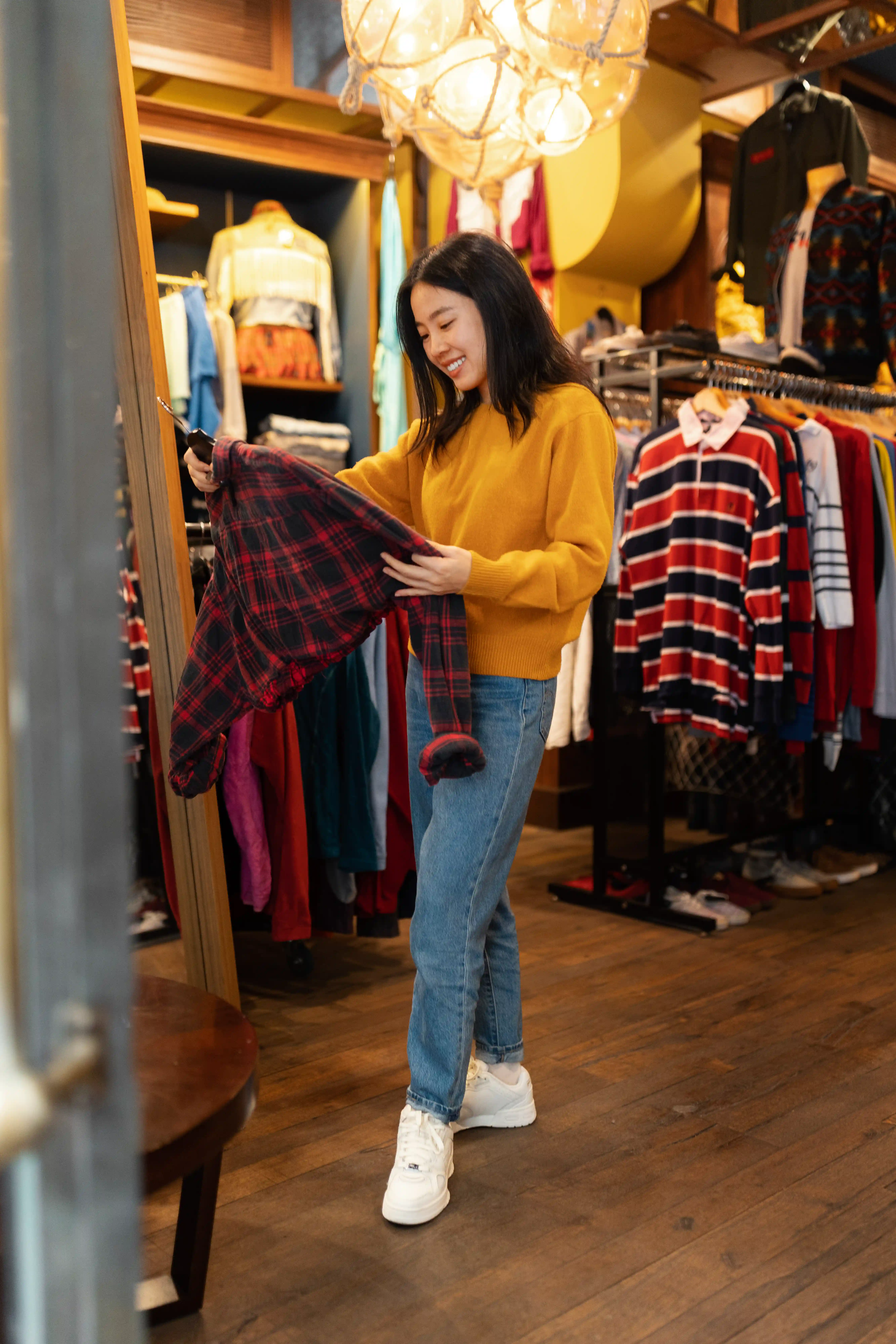 Woman shopping for clothes in thrift store